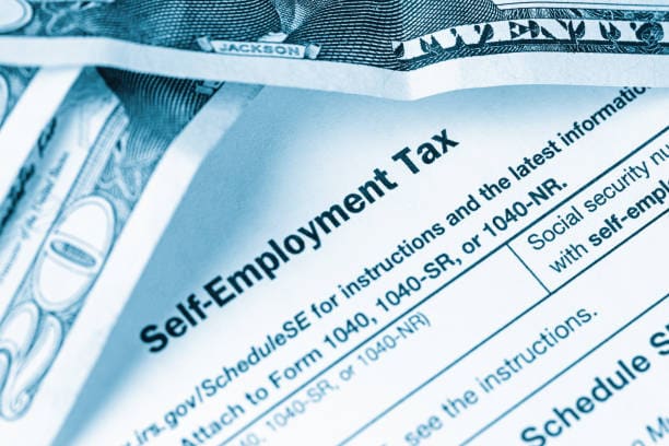 Freelancer organizing tax documents, business expenses, and 1099 income records